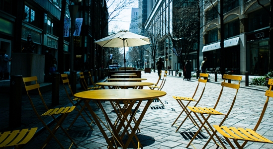 Outdoor café tables and chairs on street.